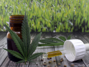 cannabidiol | Prader-Willi Syndrome News | Clinical Trials | Photo of marijuana leaves next to a dropper