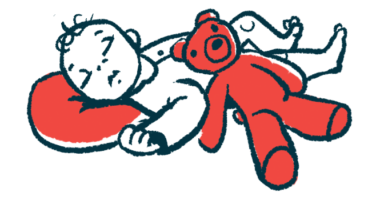 An infant sleeps with their head on a red pillow while a red teddy bear rests on their stomach.