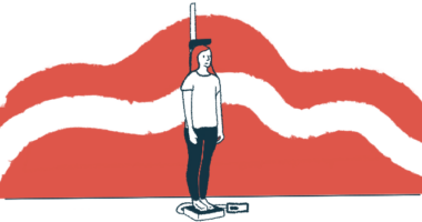 A young woman stands on a scale that measures her height.