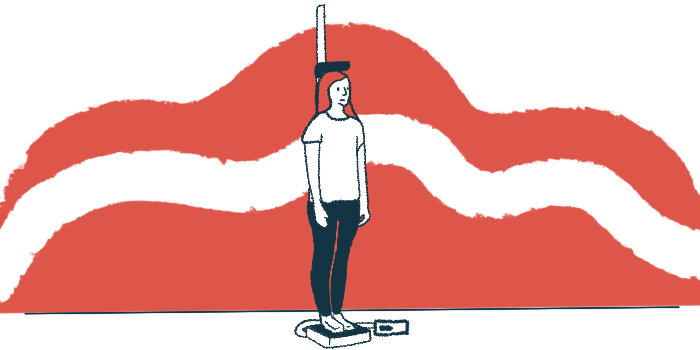 A young woman stands on a scale that measures her height.
