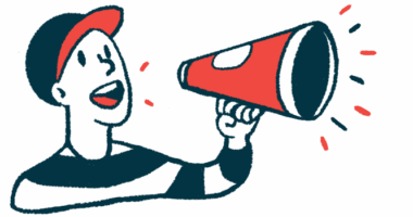 A man wearing a ballcap speaks into a megaphone to get a message out.