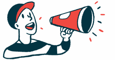 A man wearing a ballcap speaks into a megaphone to get a message out.