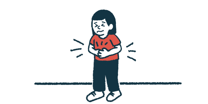 A child, looking pained, holds their stomach.