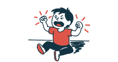 A seated child is throwing a tantrum with fists raised.