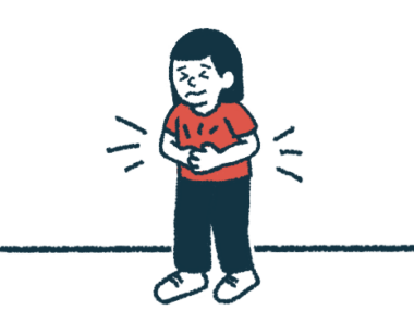 A child grimaces while holding their stomach.
